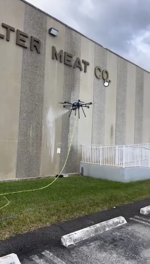 Cleaning drone washing the exterior wall at Balter Meat Co.