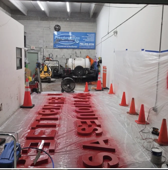 Removed Costco signage letters laid out in the workshop