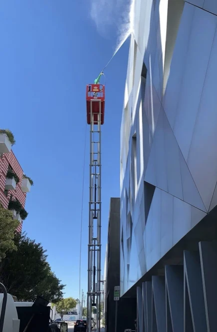 Technician working at height along the museum facade