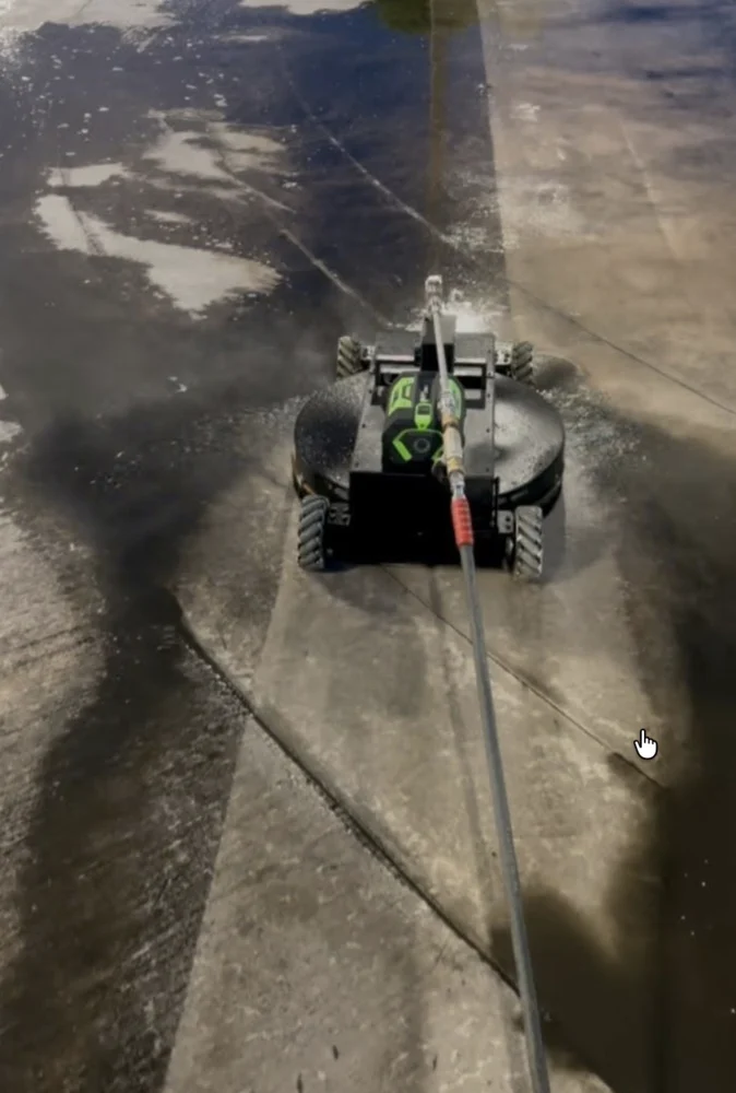 LavoBot robotic surface cleaner working on concrete at West Kendall Lexus