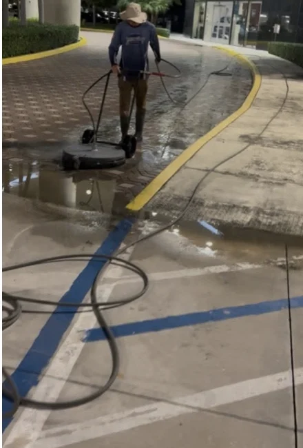 Technician cleaning a walkway at West Kendall Lexus