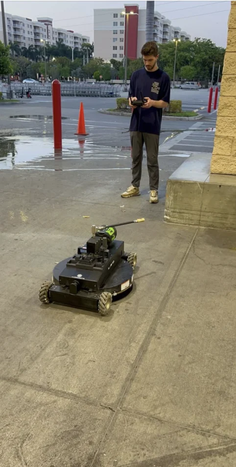 Pressure Kleen operator controlling an automated cleaning robot on a concrete surface