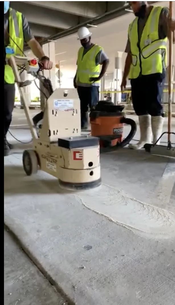 Team and surface-preparation equipment during the Memorial West thermoplastic stripe-removal project