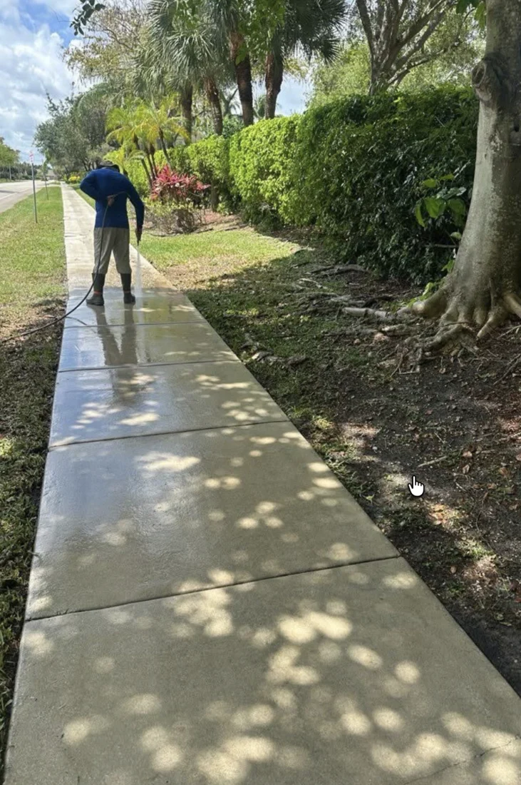 Pressure Kleen technician cleaning a sidewalk for the City of Tamarac