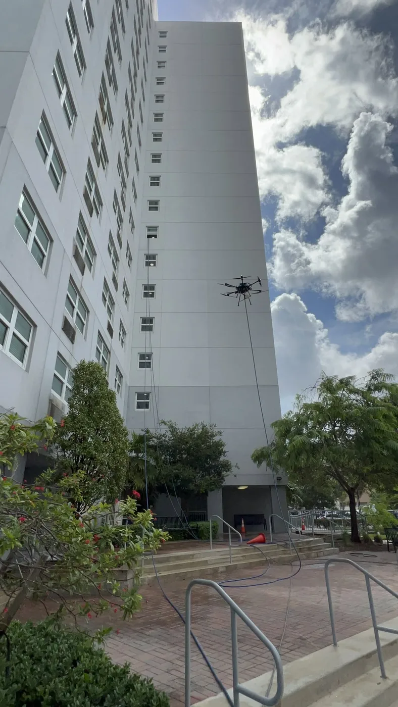 18 stories up. Drone cleaning at work.